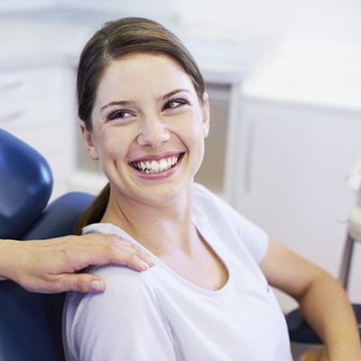 A woman at the dentist waiting for her root canals treatment