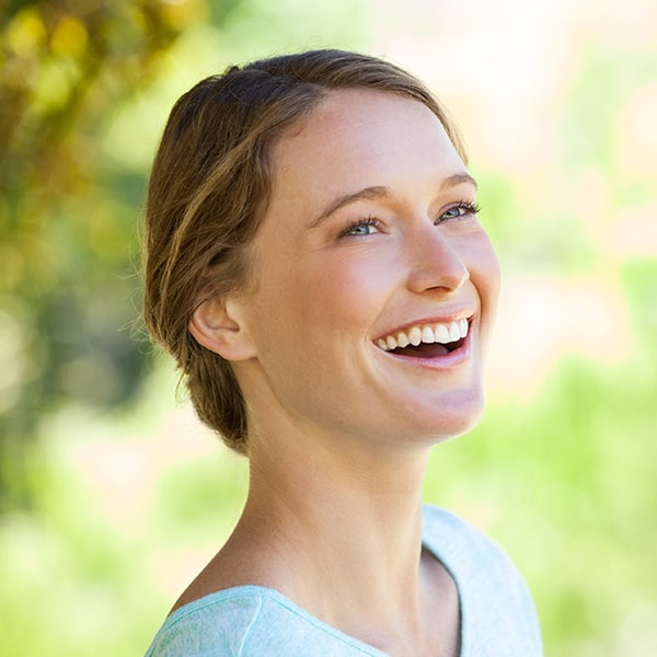 A woman smiling after her TruDenta treatment